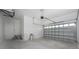 Spacious garage with high ceilings and a large roll-up door for easy vehicle storage at 10688 Mcalester Cir, Port Charlotte, FL 33981