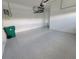 Epoxy flooring in a spacious, clean one-car garage, ready for your vehicles and storage at 10688 Mcalester Cir, Port Charlotte, FL 33981
