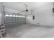 A spacious two car garage with a white door and plenty of extra storage at 10688 Mcalester Cir, Port Charlotte, FL 33981