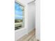 Hallway featuring a window with a view of lush greenery and plenty of natural light at 10688 Mcalester Cir, Port Charlotte, FL 33981