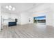 Open floor plan showcasing a modern kitchen with stainless steel appliances and a blue island at 10688 Mcalester Cir, Port Charlotte, FL 33981