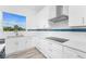 Bright kitchen with stainless appliances, sleek countertops, and white cabinets at 10688 Mcalester Cir, Port Charlotte, FL 33981