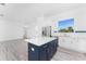 Kitchen featuring an island with a stainless steel refrigerator and view into the living room at 10688 Mcalester Cir, Port Charlotte, FL 33981