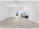 Bright open-concept living area with modern ceiling fan flowing seamlessly into the adjacent kitchen space at 10688 Mcalester Cir, Port Charlotte, FL 33981