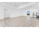 Bright and airy living room featuring light wood floors, crisp white walls, and recessed lighting at 10688 Mcalester Cir, Port Charlotte, FL 33981