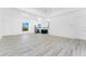 Spacious living room with new flooring and plenty of natural light at 10688 Mcalester Cir, Port Charlotte, FL 33981