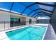Sparkling pool with a safety fence and screened enclosure, adjoining the outdoor patio at 10688 Mcalester Cir, Port Charlotte, FL 33981