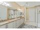 Bathroom with double sinks, a granite countertop, ample storage and large mirrors at 10953 Bullrush Dr, Venice, FL 34293
