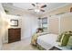 Charming bedroom features a ceiling fan, closet, and a cozy wicker chair near the window at 10953 Bullrush Dr, Venice, FL 34293