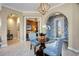 Charming foyer featuring a glass table, blue wallpaper, and archways leading to other rooms at 10953 Bullrush Dr, Venice, FL 34293