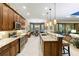 Well-equipped kitchen with granite countertops, an island bar, and views of the dining and living areas at 10953 Bullrush Dr, Venice, FL 34293