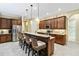 Gourmet kitchen with granite countertops, a breakfast bar, and stainless steel appliances at 10953 Bullrush Dr, Venice, FL 34293