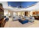 Spacious living room with blue ceiling, comfortable seating, and open access to the kitchen at 10953 Bullrush Dr, Venice, FL 34293