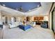 Open-concept living room featuring stylish furniture, a blue ceiling, and access to the kitchen at 10953 Bullrush Dr, Venice, FL 34293