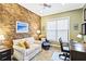 Cozy office with wood-look accent wall, comfortable seating, and a functional workspace at 10953 Bullrush Dr, Venice, FL 34293