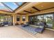 The outdoor patio has ceiling fans, furniture, a brick floor and overlooks the pool at 10953 Bullrush Dr, Venice, FL 34293
