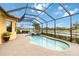 The screened-in lanai features a private pool, spa, brick pavers, and a view of the water at 10953 Bullrush Dr, Venice, FL 34293