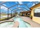 Pool and spa overlooking a lake with a screened enclosure and brick patio at 10953 Bullrush Dr, Venice, FL 34293