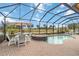 Screened-in lanai with a luxurious in-ground pool and spa overlooking a beautiful water view at 10953 Bullrush Dr, Venice, FL 34293