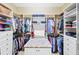 A spacious walk-in closet offers ample storage with custom shelving and hanging space at 10953 Bullrush Dr, Venice, FL 34293