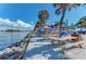 Outdoor seating area along the waterfront with picnic tables and sunny sky at 10953 Bullrush Dr, Venice, FL 34293