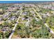 Aerial view of a charming home nestled among lush trees in a tranquil neighborhood near the ocean at 1183 Cedar Ave, Englewood, FL 34223