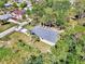Aerial view of a single-Gathering home with a well-maintained roof and landscaping in a serene, tree-filled neighborhood at 1183 Cedar Ave, Englewood, FL 34223