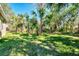 Lush backyard with mature trees, offering a private and serene outdoor space at 1183 Cedar Ave, Englewood, FL 34223