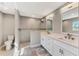 Bright bathroom featuring a walk-in shower, tile floors, and a dual vanity with modern fixtures at 1183 Cedar Ave, Englewood, FL 34223