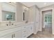Light and airy bathroom with double vanity, quartz countertop, and wood-look flooring at 1183 Cedar Ave, Englewood, FL 34223