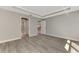 Spacious bedroom with tray ceiling, modern flooring, and access to other rooms at 1183 Cedar Ave, Englewood, FL 34223