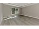 Inviting bedroom with tray ceiling, natural light, and modern flooring at 1183 Cedar Ave, Englewood, FL 34223