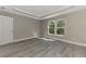 Open bedroom with large window providing natural light, paired with modern flooring at 1183 Cedar Ave, Englewood, FL 34223