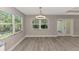 Well-lit dining area with stylish light fixture, a large window, and access to the living area at 1183 Cedar Ave, Englewood, FL 34223