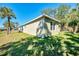 Exterior shot of a well-maintained home with a manicured lawn and palm trees at 1183 Cedar Ave, Englewood, FL 34223