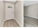 Inviting foyer featuring gray walls, white trim, and wood-look flooring, leading to a spacious room at 1183 Cedar Ave, Englewood, FL 34223