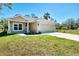 Attractive single-Gathering home with a two-car garage, well-maintained lawn, and appealing curb appeal at 1183 Cedar Ave, Englewood, FL 34223
