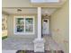 Inviting front porch with stone accents, stylish lighting, and a well-manicured landscape at 1183 Cedar Ave, Englewood, FL 34223