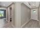 Bright hallway featuring gray walls, white trim, and a view of the front door and adjacent room at 1183 Cedar Ave, Englewood, FL 34223