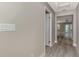 Neutral hallway featuring gray walls, white trim, wood-look flooring, and recessed lighting at 1183 Cedar Ave, Englewood, FL 34223