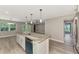 Modern kitchen island with stainless steel sink overlooks a spacious living area with recessed lighting and ceiling fan at 1183 Cedar Ave, Englewood, FL 34223