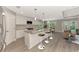 Bright, open kitchen with a large island, modern appliances, and wood-look flooring at 1183 Cedar Ave, Englewood, FL 34223