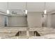 Open-concept kitchen features a marble island with a sink, pendant lighting, and views into the living areas at 1183 Cedar Ave, Englewood, FL 34223