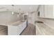 Kitchen featuring white cabinets, granite counters, stainless appliances, and a large island at 1183 Cedar Ave, Englewood, FL 34223