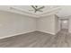 Spacious living room with gray floors, a tray ceiling, and a view towards the entry hall at 1183 Cedar Ave, Englewood, FL 34223