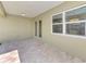 Covered patio with tiled flooring, windows, and views of the home's exterior at 1183 Cedar Ave, Englewood, FL 34223