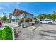 Outdoor dining area with a wooden pergola and a view of the parking area at 1183 Cedar Ave, Englewood, FL 34223