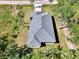 Aerial view of a well-maintained roof, surrounded by lush greenery and mature trees, enhancing the property's curb appeal at 1183 Cedar Ave, Englewood, FL 34223