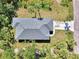 Overhead aerial view of a house roof showing details and yard with palm trees, and concrete driveway at 1183 Cedar Ave, Englewood, FL 34223