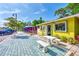 Bright yellow storefront with outdoor seating and a 'Downtown Jewelers' sign at 1183 Cedar Ave, Englewood, FL 34223